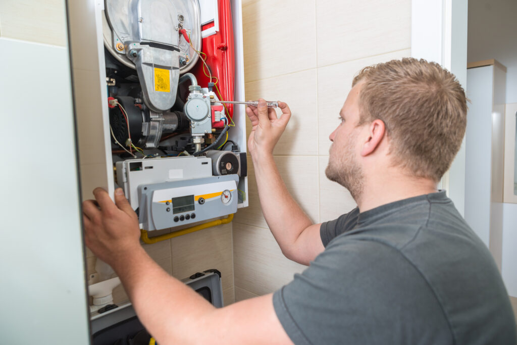 Technician repairing Gas Furnace.